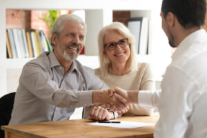 Couple shaking hands with a title agent