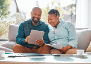 two people sitting and looking at paperwork